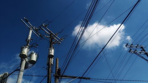 Low angle view of electricity pylon against sky