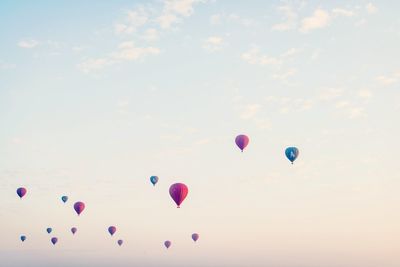 Low angle view of balloons flying against sky