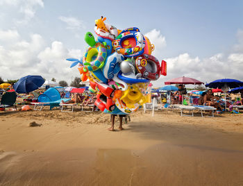 People on beach against sky