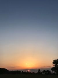 Scenic view of silhouette landscape against clear sky during sunset