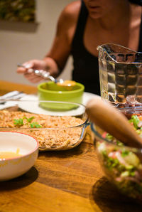 Close-up of hand holding drink served on table