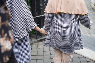 Rear view of couple walking on street