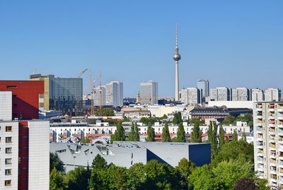 Cityscape against clear blue sky