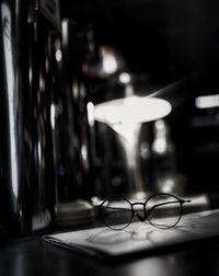 Close-up of illuminated eyeglasses on table