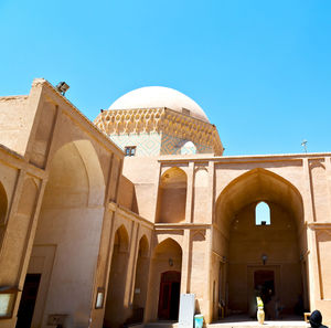 Low angle view of historical building against clear blue sky