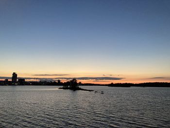 Scenic view of sea against clear sky during sunset