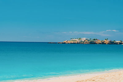 Scenic view of sea against blue sky