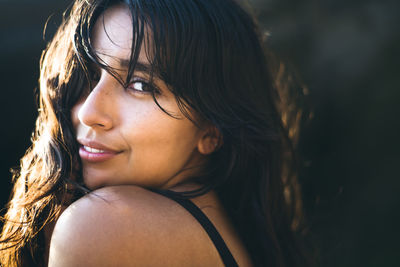 Young latina woman portrait at golden hour in summertime