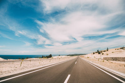 Road by land against sky