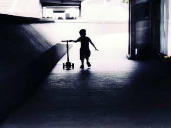 Rear view of silhouette man standing in building