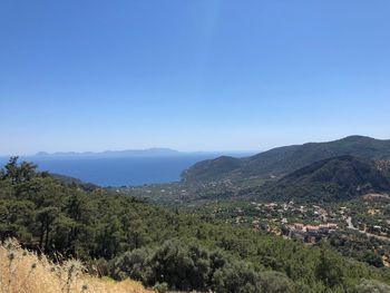 Scenic view of mountains against clear blue sky