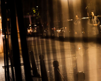 Reflection of illuminated lights in puddle