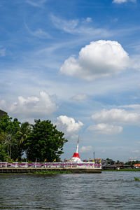 Scenic view of river by building against sky