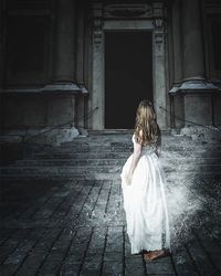 Full length of woman standing on bench