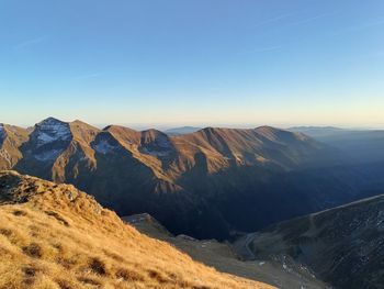 Scenic view of mountains against clear blue sky