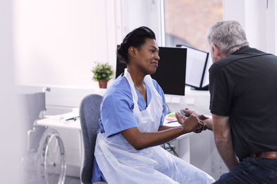 Female doctor checking patient's pulse