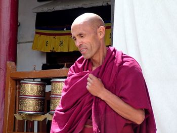 Portrait of smiling man standing at temple