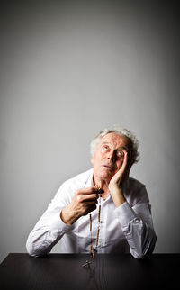 Portrait of man sitting on table