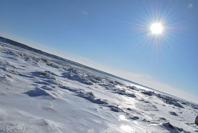 Snow covered mountain against blue sky