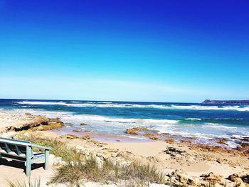 Scenic view of sea against clear blue sky