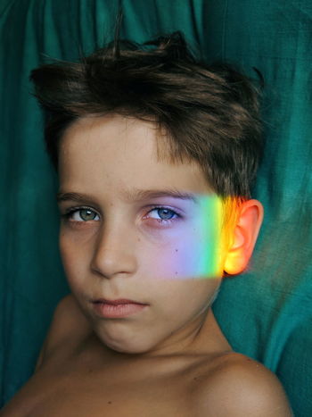 Prims light falling on face of shirtless boy