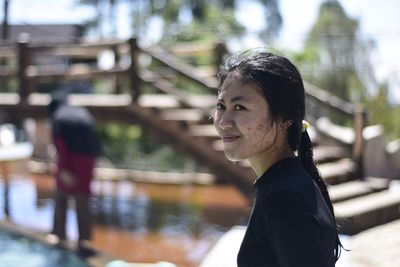 Portrait of young woman standing outdoors