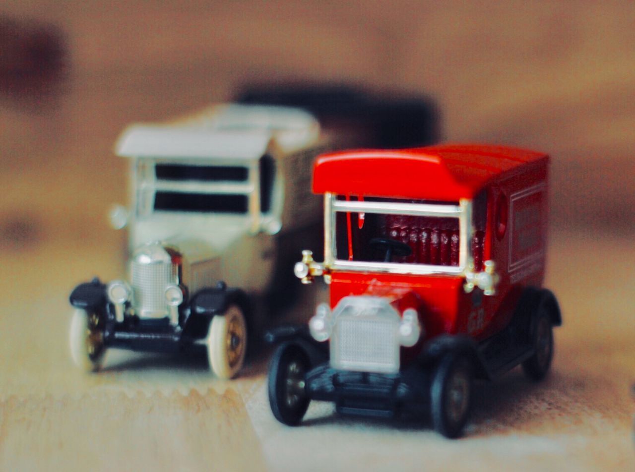 CLOSE-UP OF TOY CAR ON TABLE IN BUS