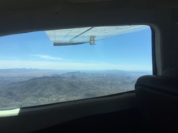 Aerial view of landscape seen through airplane window