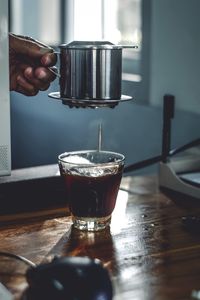 Man holding coffee cup on table