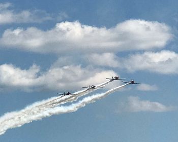Low angle view of airshow against sky