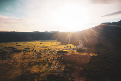 Scenic view of landscape against sky during sunset while on a helicopter