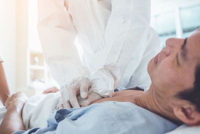 Midsection of woman lying on bed