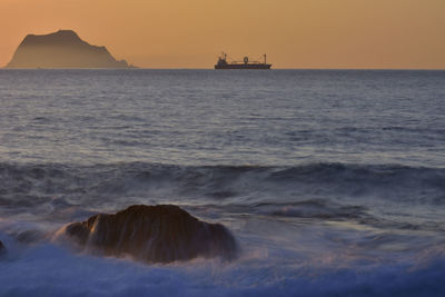 Scenic view of sea against clear sky during sunset