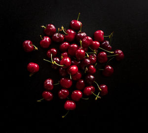 Close-up of cherries against black background