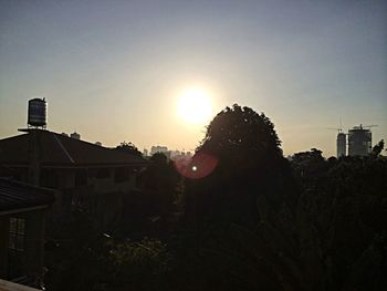 Silhouette of building against sky at sunset