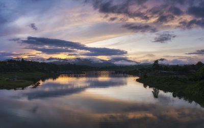 Scenic view of lake against sky at sunset