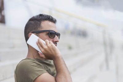 Man talking on phone while standing outdoors