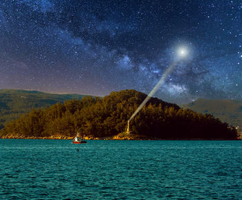 Scenic view of sea against sky at night