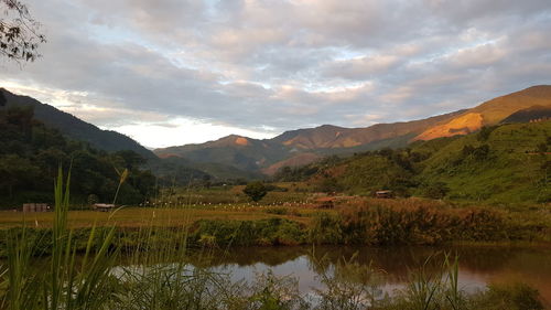 Scenic view of lake and mountains against sky