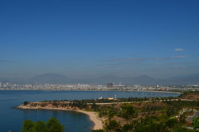 Scenic view of sea and city against sky