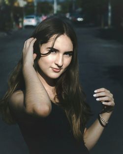 Portrait of teenage girl standing on road