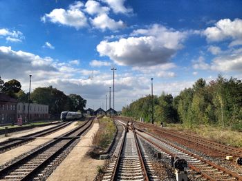 Railroad track against cloudy sky