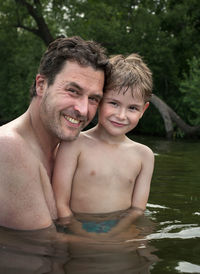 Portrait of father with boy in water