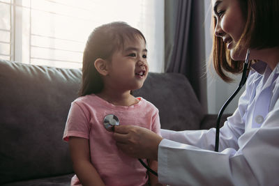 Doctor examining child at clinic