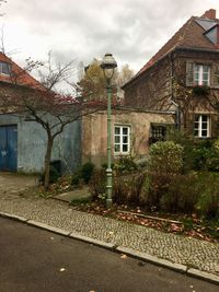 Street by buildings against sky