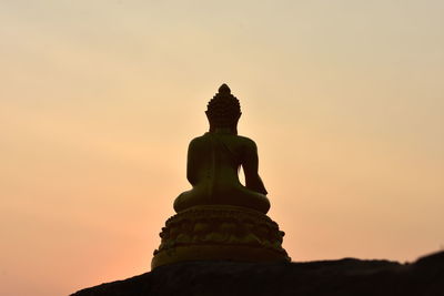 Low angle view of statue against sky