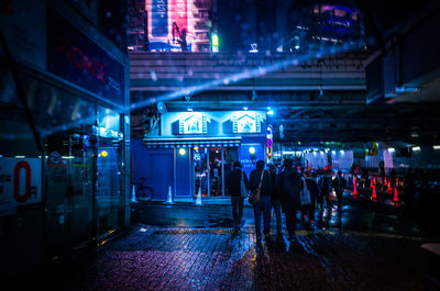 People at illuminated city at night