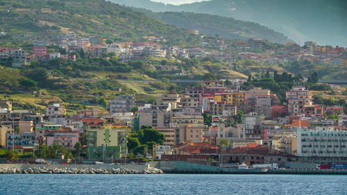 Aerial view of townscape by sea