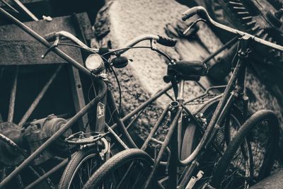 Close-up of old bicycles parked on land