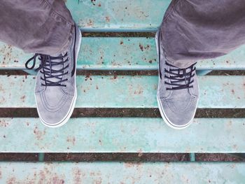 Low section of man standing on metal structure